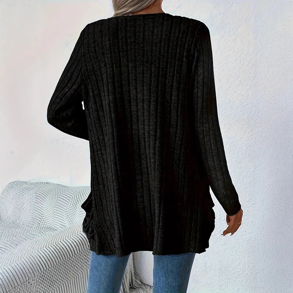 A person wearing a solid grey loose fit long sleeve cardigan with a chest pocket.