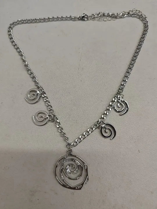 Spiral donut design women's jewellery set showing matching necklace, bracelet, and ear hooks in gold electroplated finish