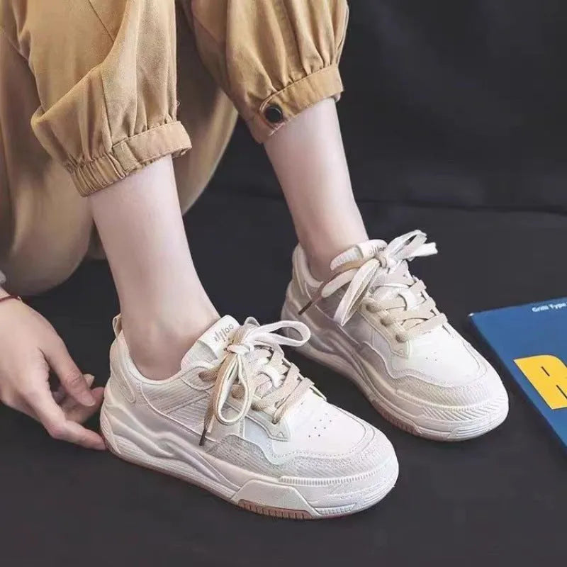 Beige and pink low-top sneakers with rubber soles and imitation leather lining