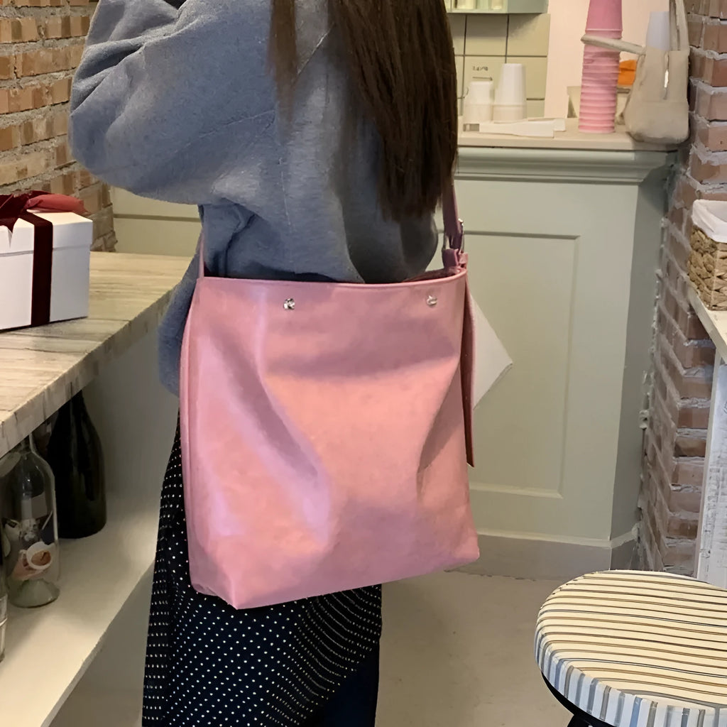 Pink corduroy one-strap shoulder bag with PU lining, showing its 39cm length.