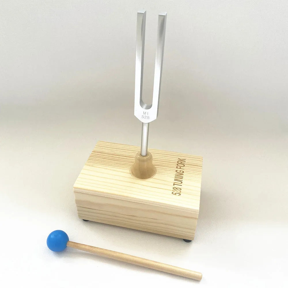 Aluminium alloy 432Hz tuning fork with connected speaker on kraft paper box
