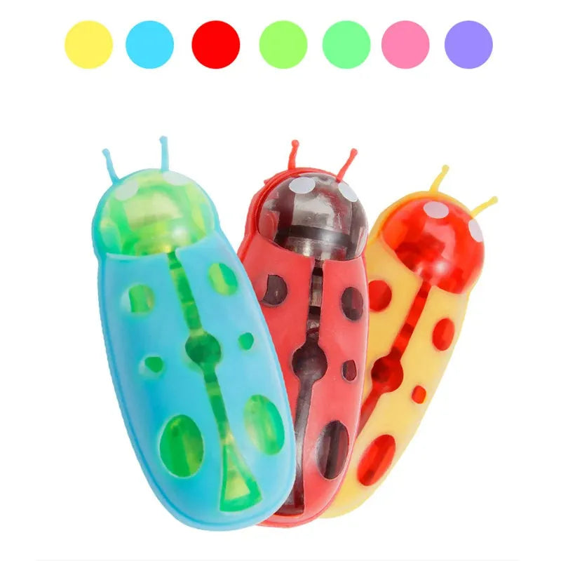 Small motorised insect pet toy in red ladybird design on wooden floor