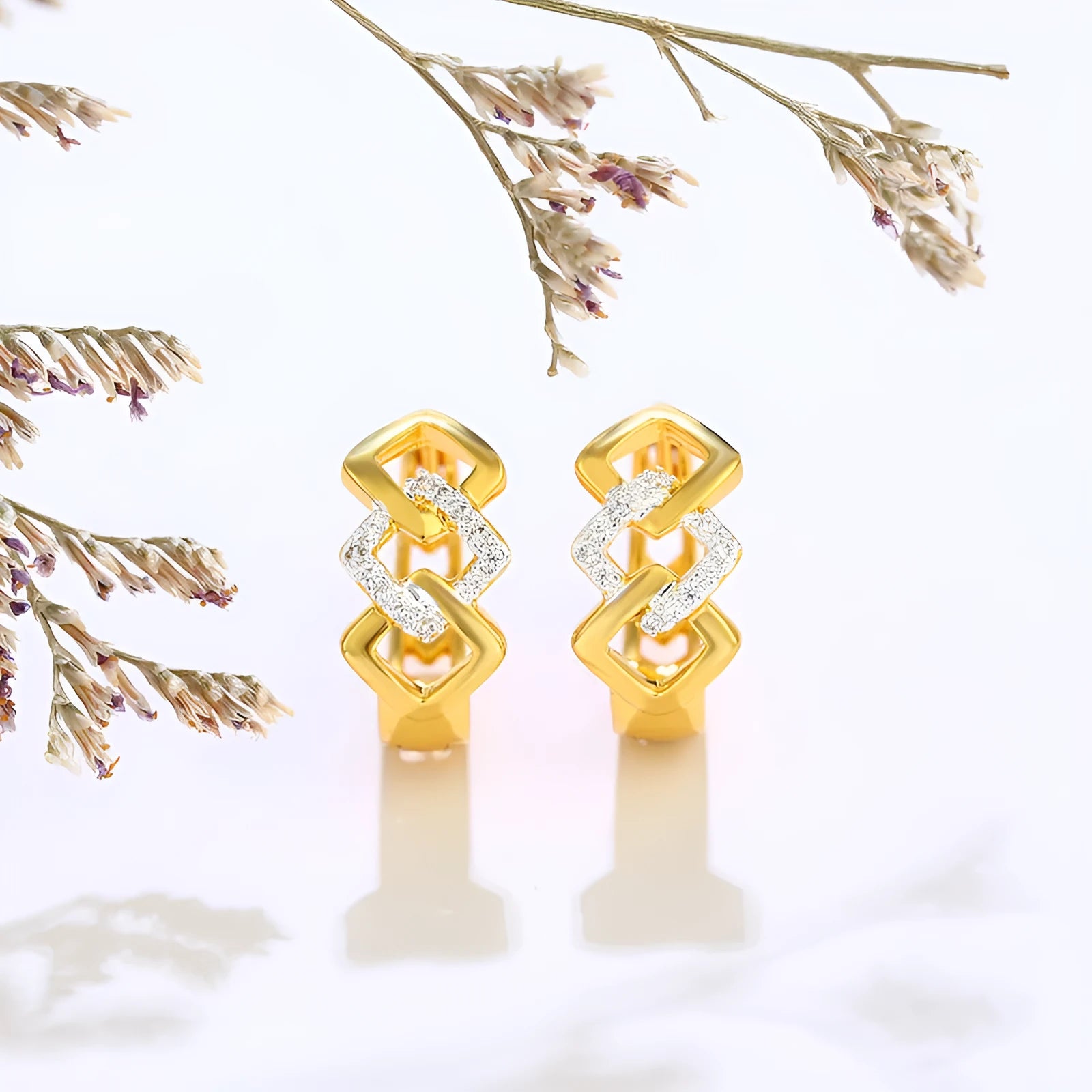 Geometric hollow-out gold electroplated ear clip earrings showing colour separation detail