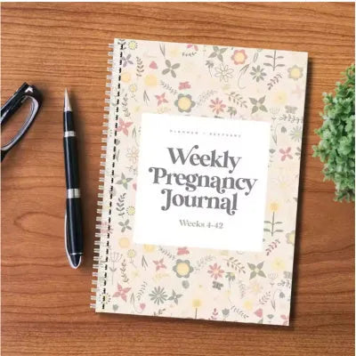 A5 pregnancy weekly diary notebook open showing weekly pregnancy tracking pages