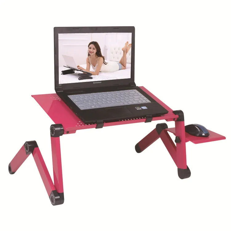 Red folding metal laptop desk with cooling fan and mouse board extended over a bed.