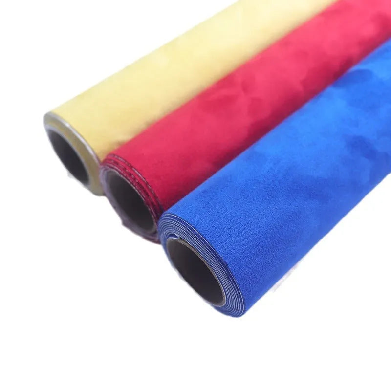 Roll of self-adhesive leather suede fabric in BMW brown colour next to a car dashboard.
