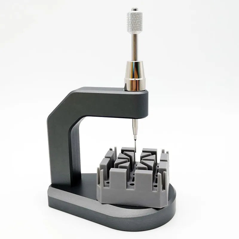 Silver multi-purpose press strap removal tool with a pointed blade for watch and jewellery repair.