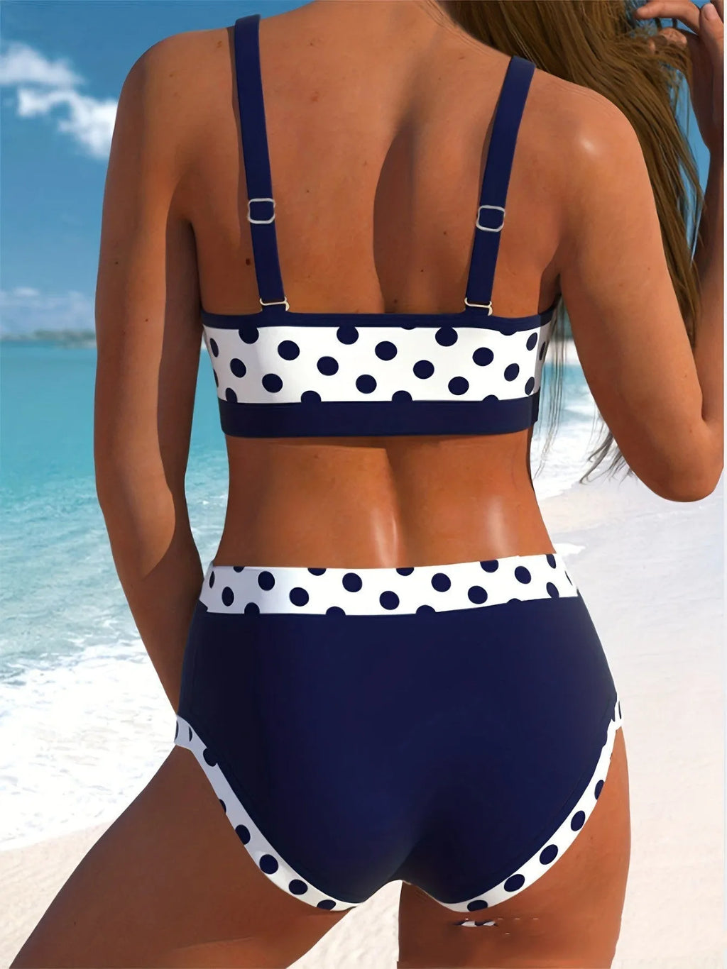 Women's multicolour polka dot split bikini set on a white background.