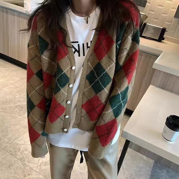 Acrylic knitted cardigan coat in light khaki colour, shown on a hanger.