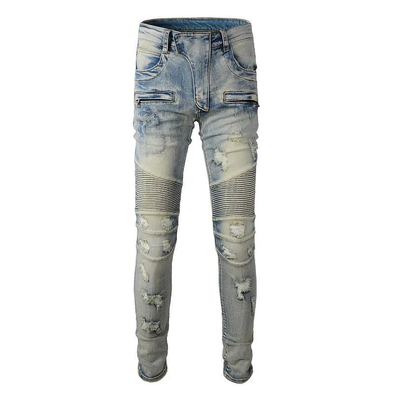 Men's light blue slim fit distressed stretch jeans with hand-frayed detailing on a mid waist with zipper fly.