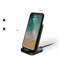 Dark grey vertical wireless charging stand for Apple iPhones on desktop