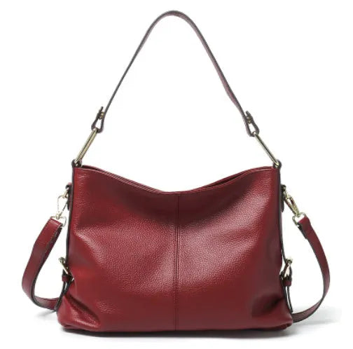 Genuine leather crossbody bag in a vertical square shape with visible sewing lines and a crossbody strap.