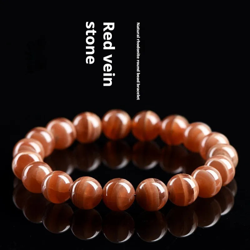 Natural old mine rhodochrosite round bead bracelet with ruyi design element.