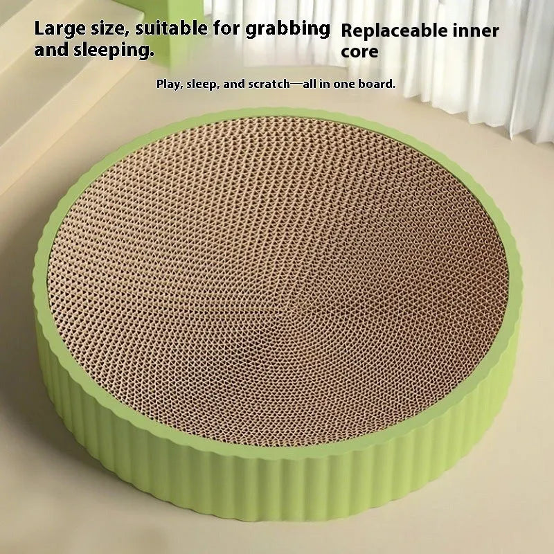 Round green cat scratching board with replaceable corrugated centre measuring 55 cm diameter