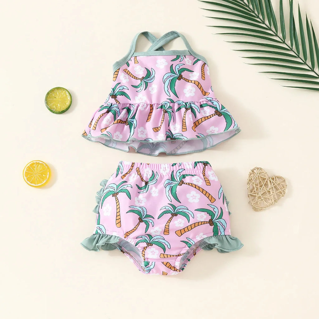 Girls' white two-piece swimsuit set with a shirt and matching shorts on a hanger