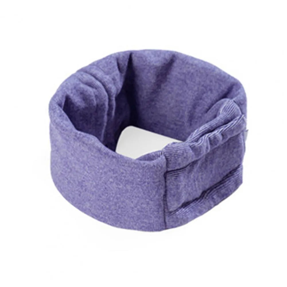 A black dog wearing a purple polyester calming hoodie that covers its head and ears.
