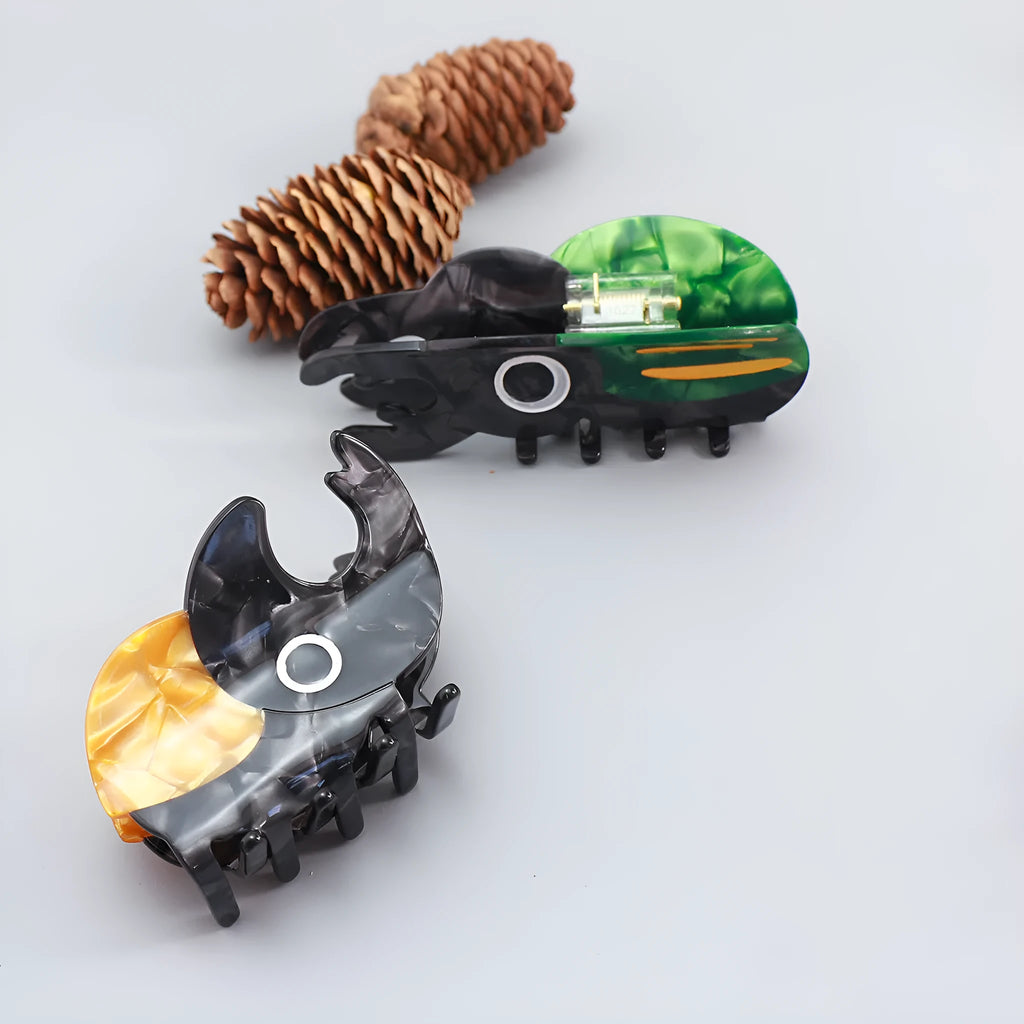 Handmade cellulose acetate beetle grip showing green beetle, orange beetle, and white caterpillar colour variants