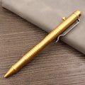 Brass tactical pen with bolt-action mechanism showing brushed finish and retro hole detailing