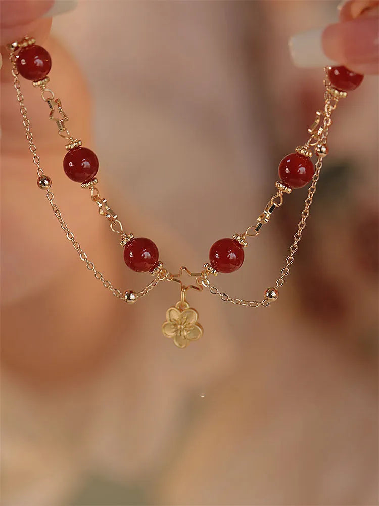 Women's double layer red agate bracelet with peach blossom flower elements and ethnic design