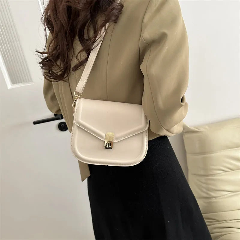 Soft PU leather clamshell messenger bag in a horizontal square shape on a shoulder strap.