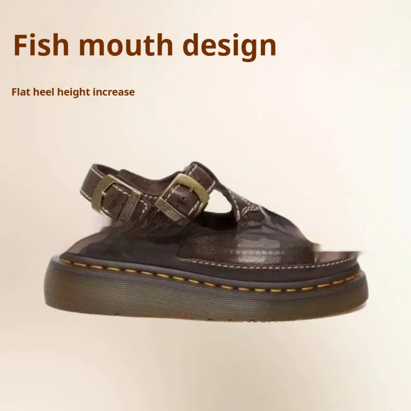 Men's black embroidered floral beach sandals with flat heel on a sandy background.