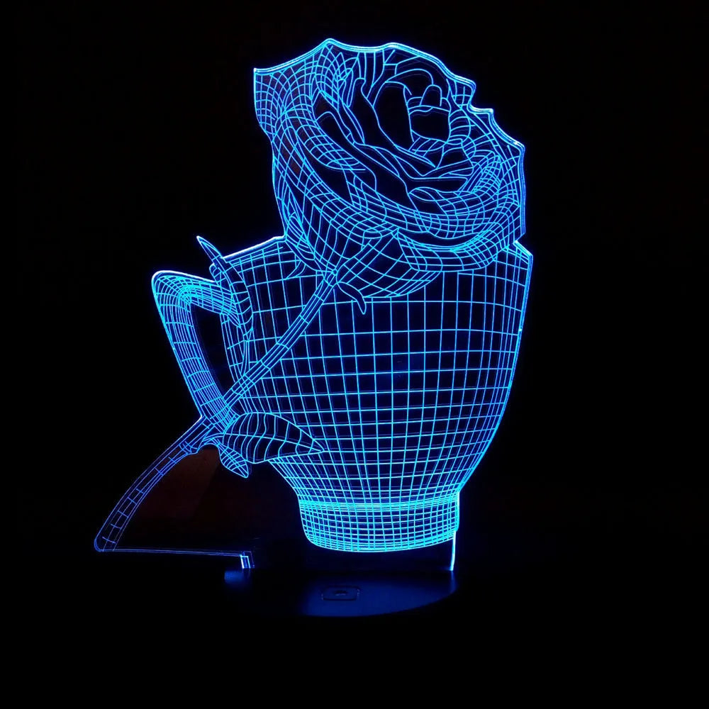 A 3D acrylic rose LED night light with a black base, displaying a purple glow, sitting on a wooden surface.