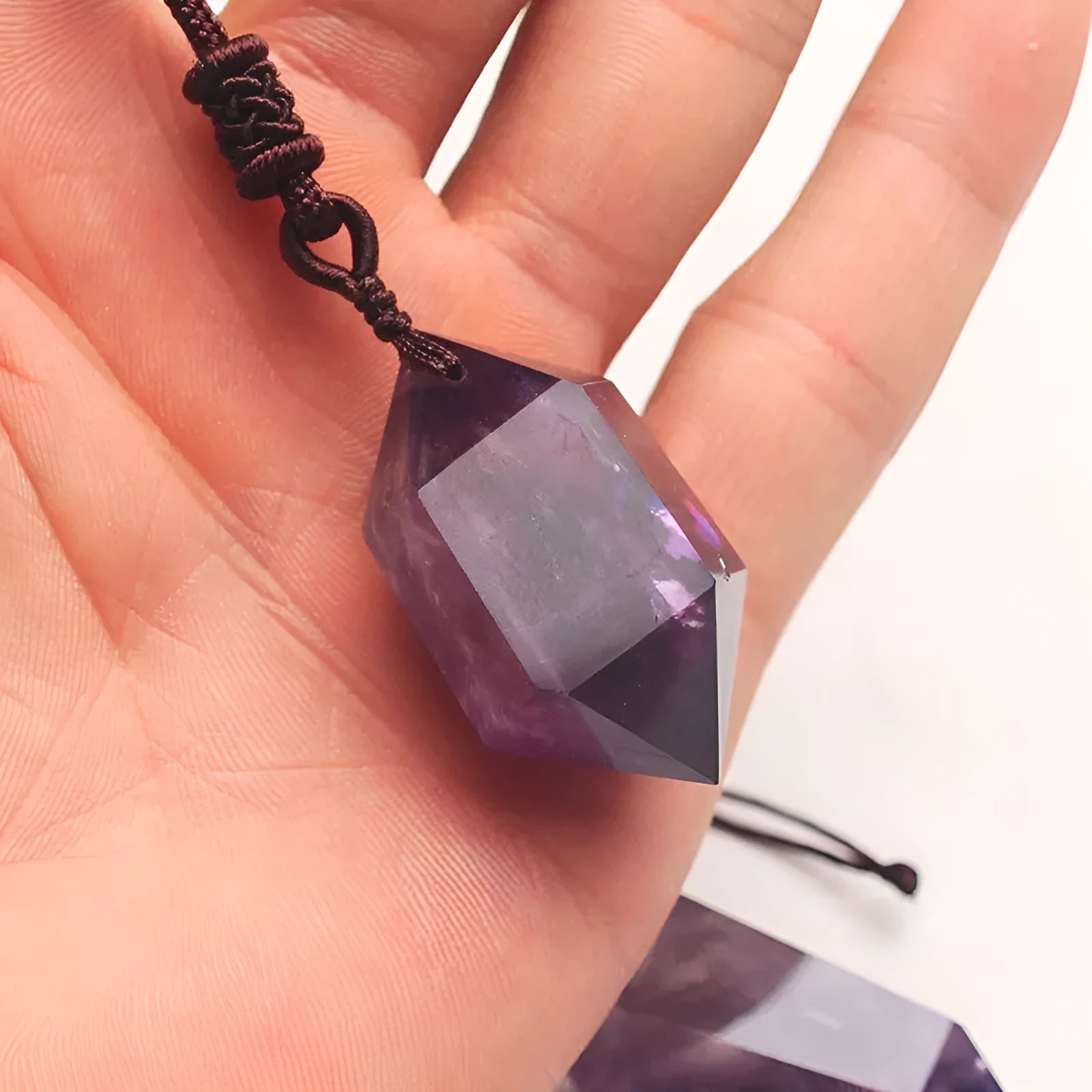 Natural amethyst hexagonal pendant with adjustable chain on purple background