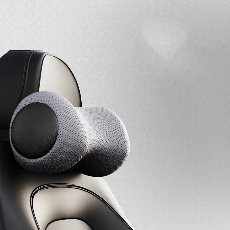 A black car massage cushion with electric vibration controls, placed on a car seat for neck and lumbar support.