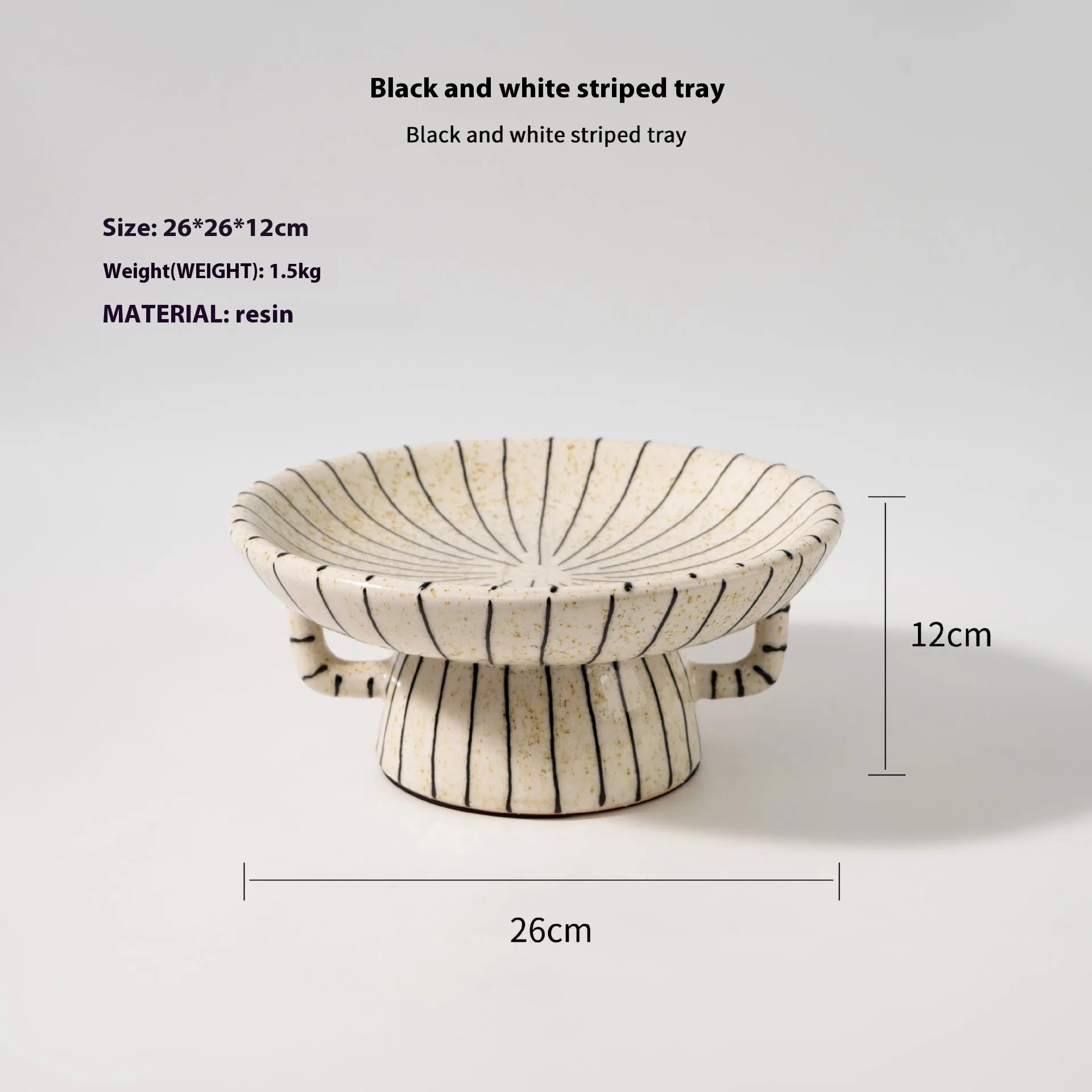 Black and white striped plastic resin fruit plate on a wooden surface.