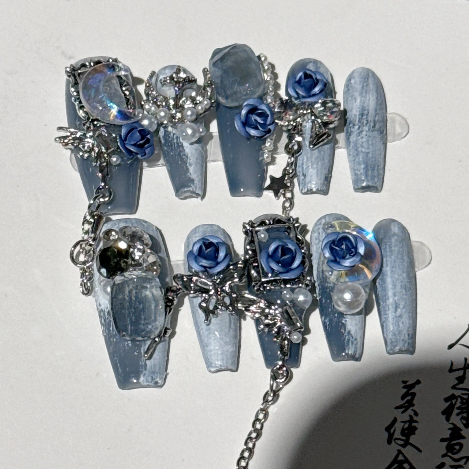 Evening manicure set in heavy industry night blue with rose, tulip, and flower patterns on plastic armour suit