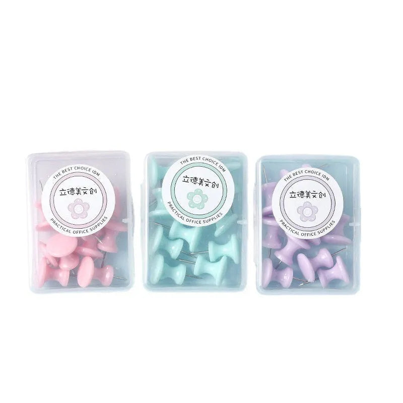 Plastic push pins in cherry blossom pink, mint green, and lavender, showing large and small sizes on a corkboard