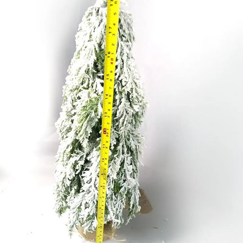 24-inch plastic artificial Christmas tree with snow sprayer and integrated lights on desktop
