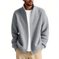 Man wearing a loose-fit grey cardigan sweater, a casual base layer for leisure wear.
