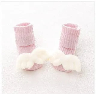 Cotton baby floor socks with non-slip soles in a pink bow print design.