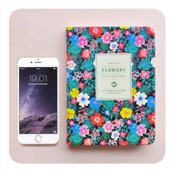 Green floral pattern notepad with fabric leather cover showing wireless binding and open pages