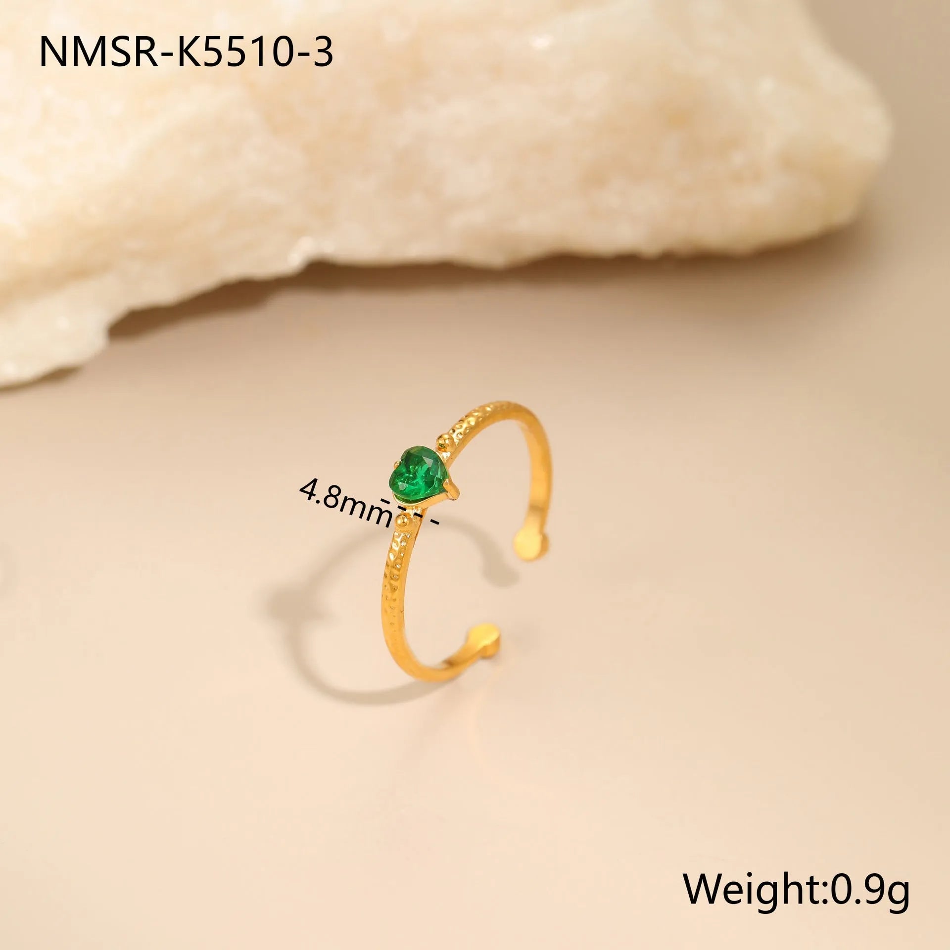 Open-ended geometric stainless steel ring with a green zircon heart inlay on a grey background.