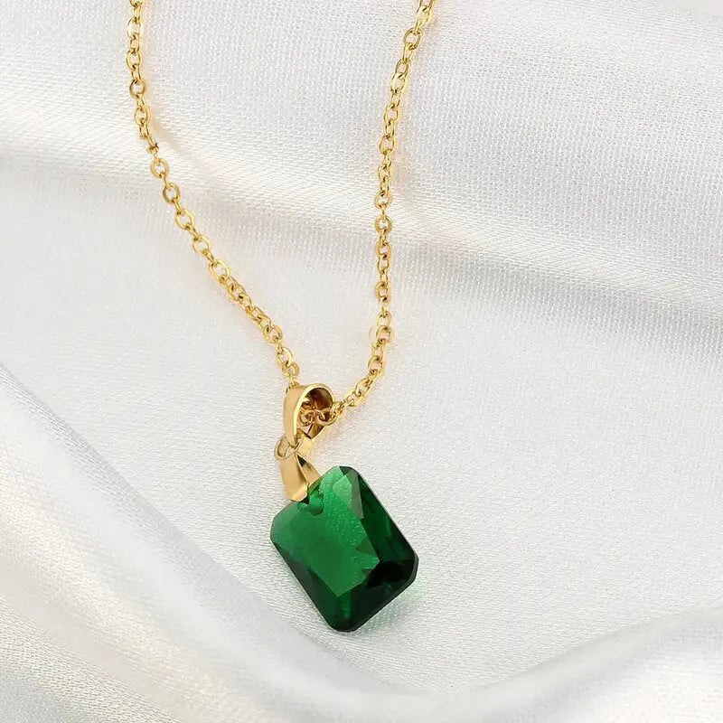 Copper rectangular geometric pendant necklace on an O-ring chain in a retro green colour.