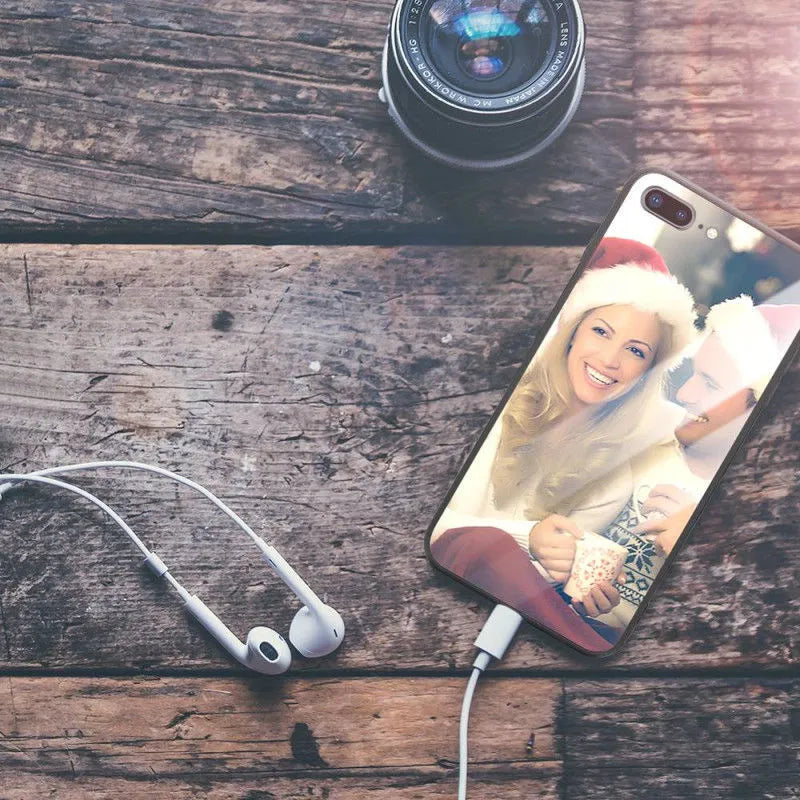 Patterned iPhone case with raised edges on a table next to an iPhone.