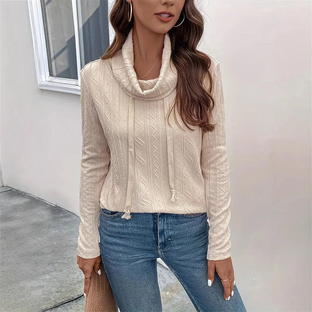 Apricot coloured long sleeve hooded pullover sweater on a hanger.