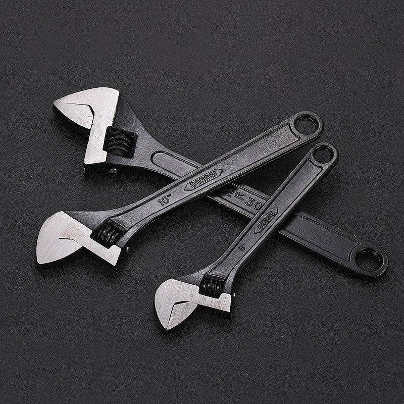 High carbon steel adjustable open-end wrench with blackened finish on a grey background.