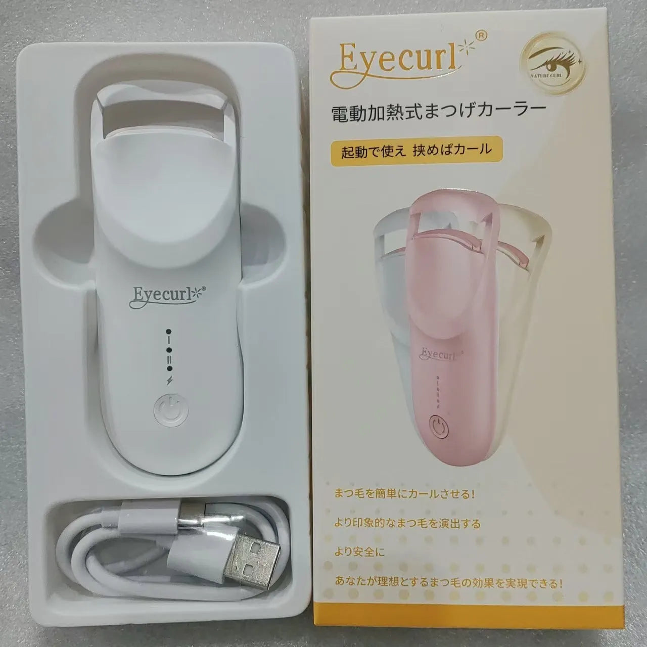 USB electric eyelash curler in cream white, pink, or apricot with charging cable.