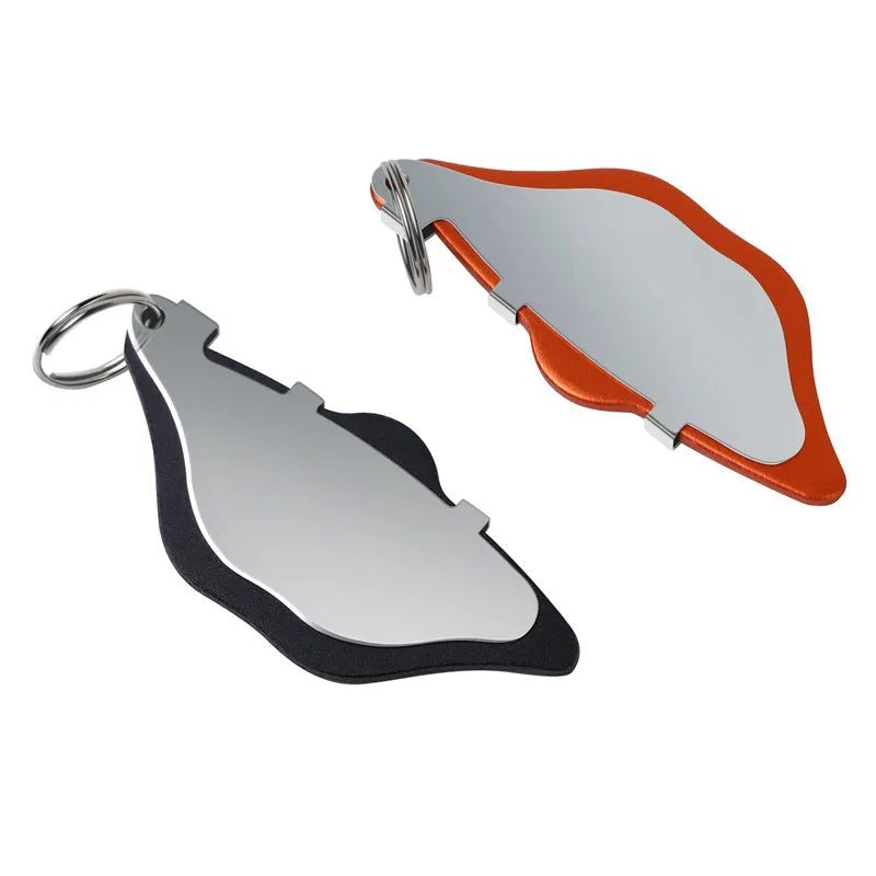 Black and orange metal mountain bike disc brake pads with an adjustment flap.