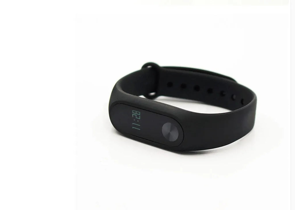 Xiaomi Mi Band 2 black fitness band with OLED screen showing heart rate data on a wrist.