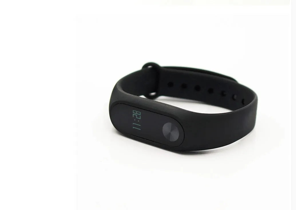 Xiaomi Mi Band 2 black fitness band with OLED screen showing heart rate data on a wrist.