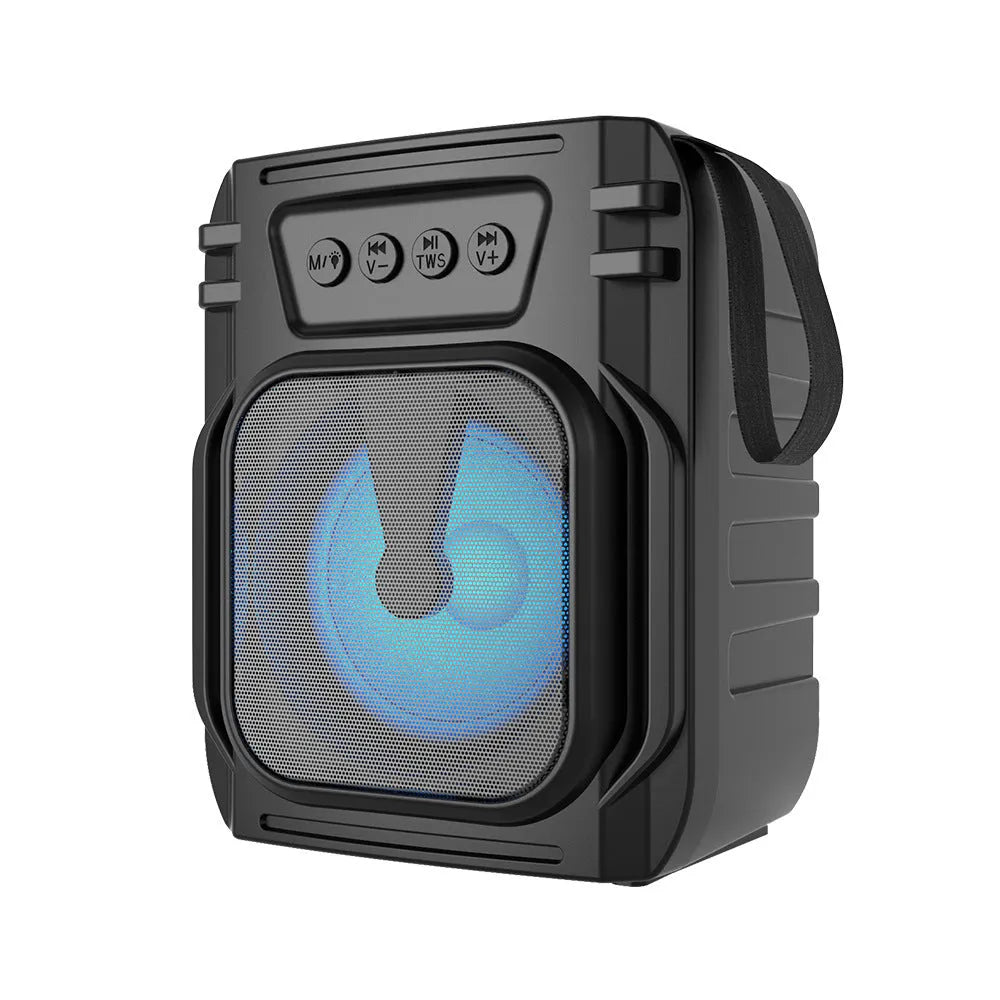 Compact portable Bluetooth speaker in neutral colour with USB charging cable.