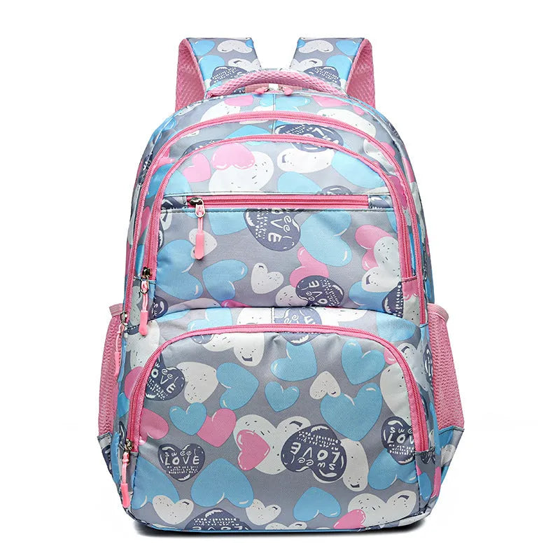 Blue children's school backpack with air pillow straps on a grey background.