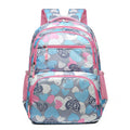 Blue children's school backpack with air pillow straps on a grey background.