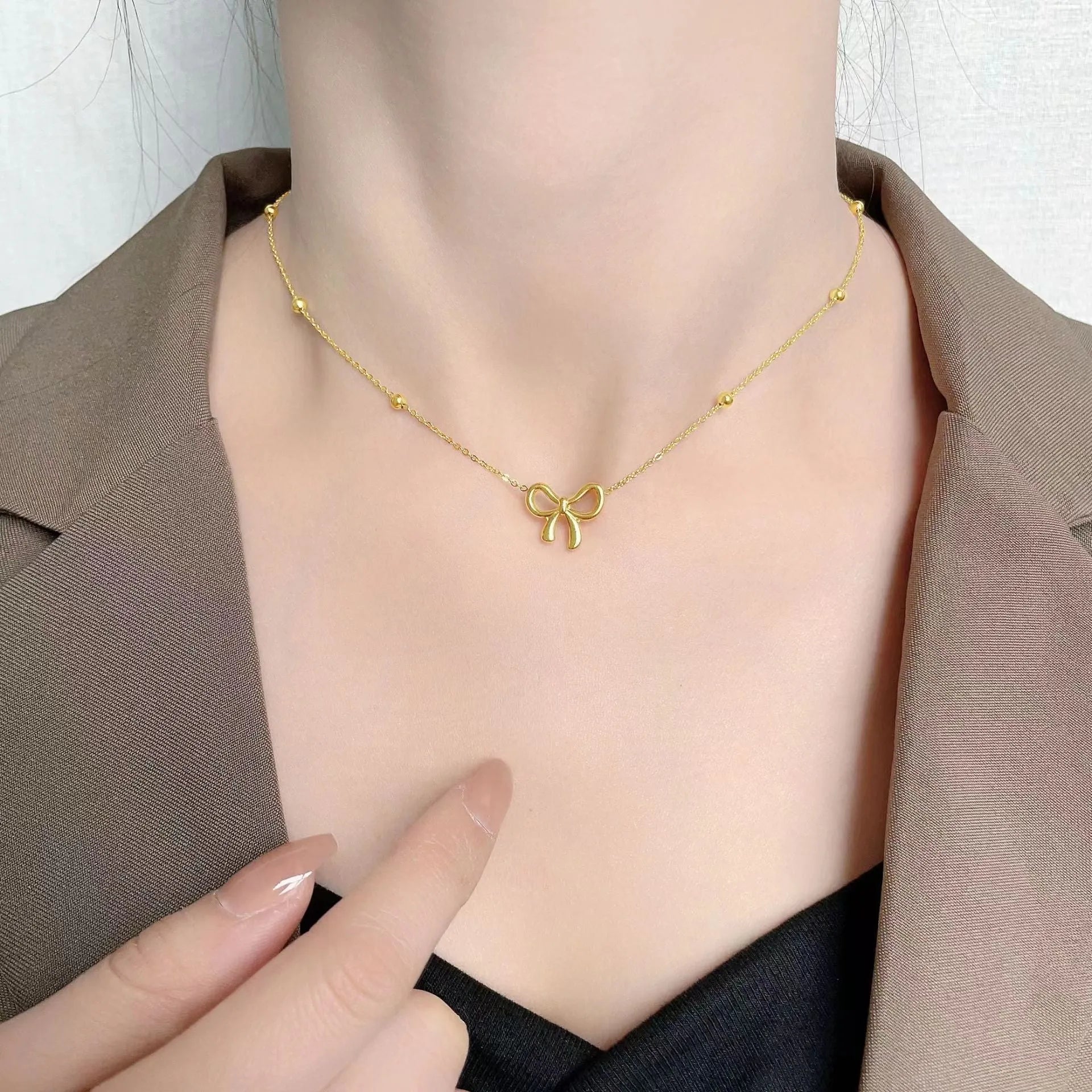 Gold titanium steel bow necklace with cross chain design, adjustable 41-50cm length
