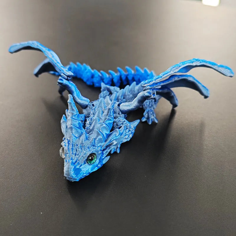 3D printed red and gold flying dragon wings decoration toy on a white background.