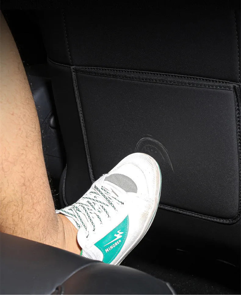 Black leather rear anti kick pad for car seats, measuring 68cm by 42cm.